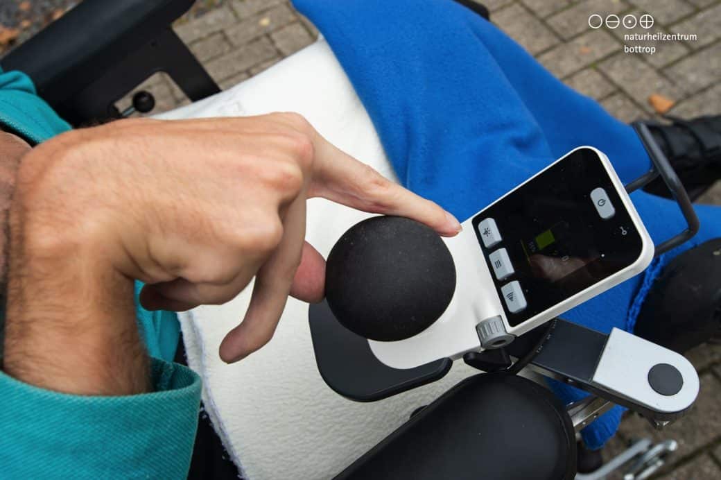 Close-up of a hand with wheelchair control unit