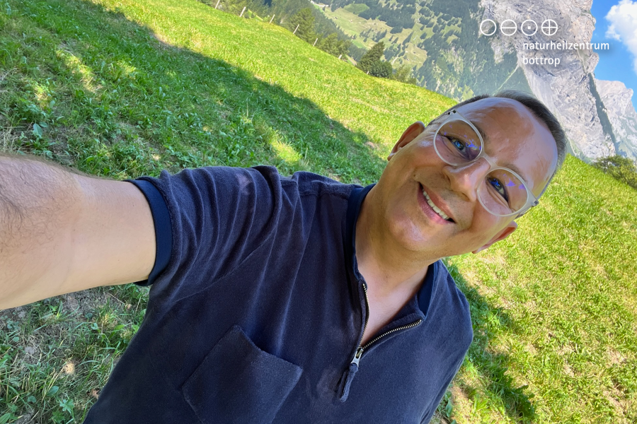 Alternative practitioner Farid Zitoun takes a selfie in front of alpine panorama