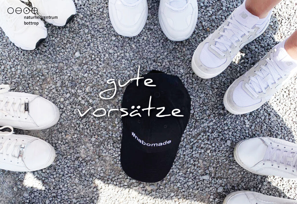 White sneakers in gravel around black cap 