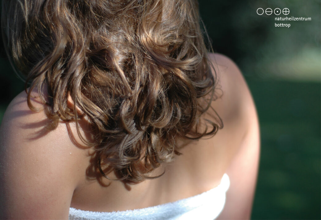 Back view of a woman with curly hair