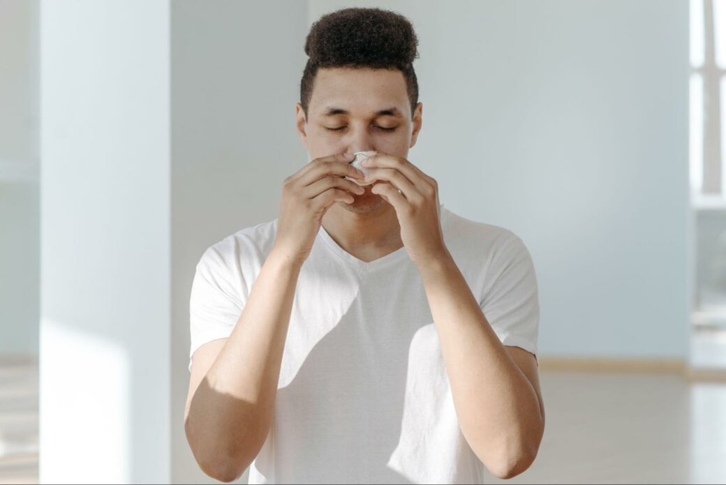 White-clad man inhaling